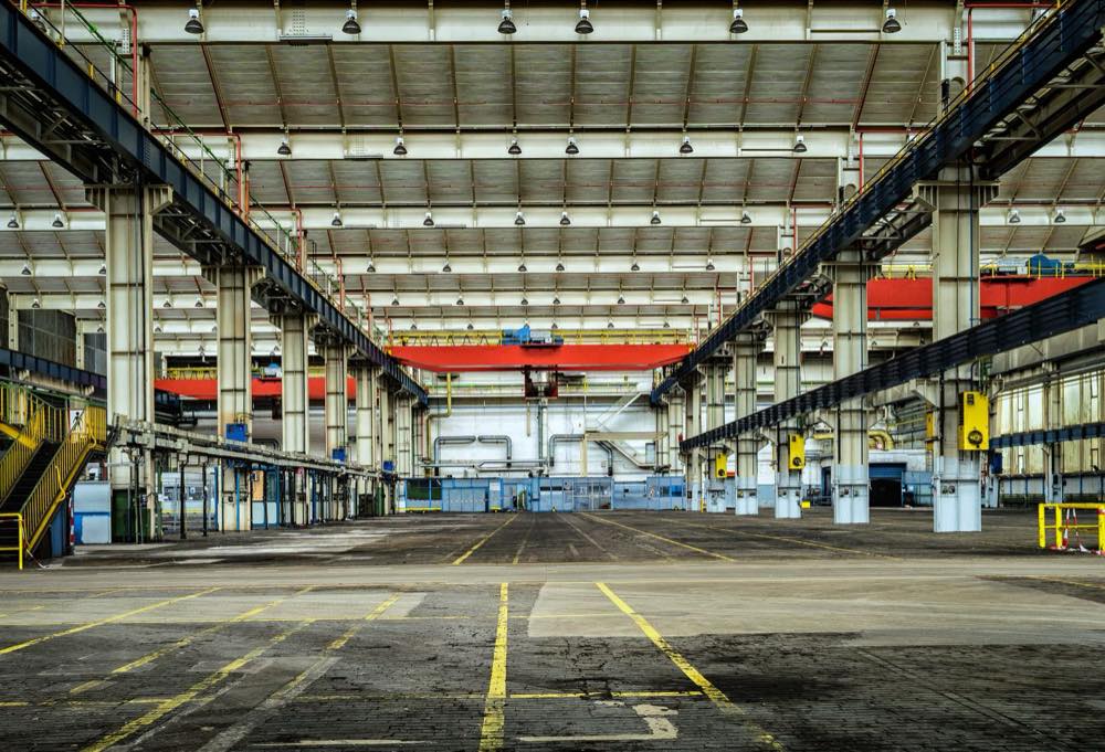 Large industrial hall with yellow lane markings on the floor