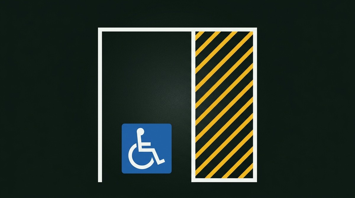 Accessible parking bay outlined in white with a blue patch and white wheelchair symbol, beside a yellow hatched shared zone
