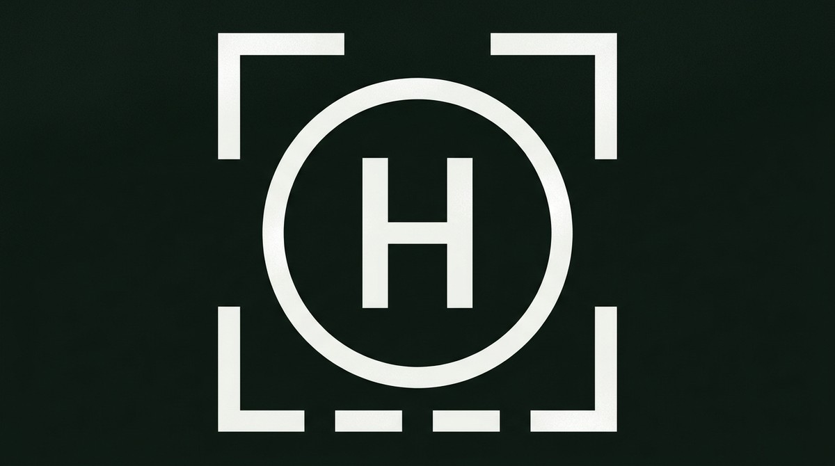 Helipad marking: a large white H inside an unbroken white circle with a broken square perimeter line