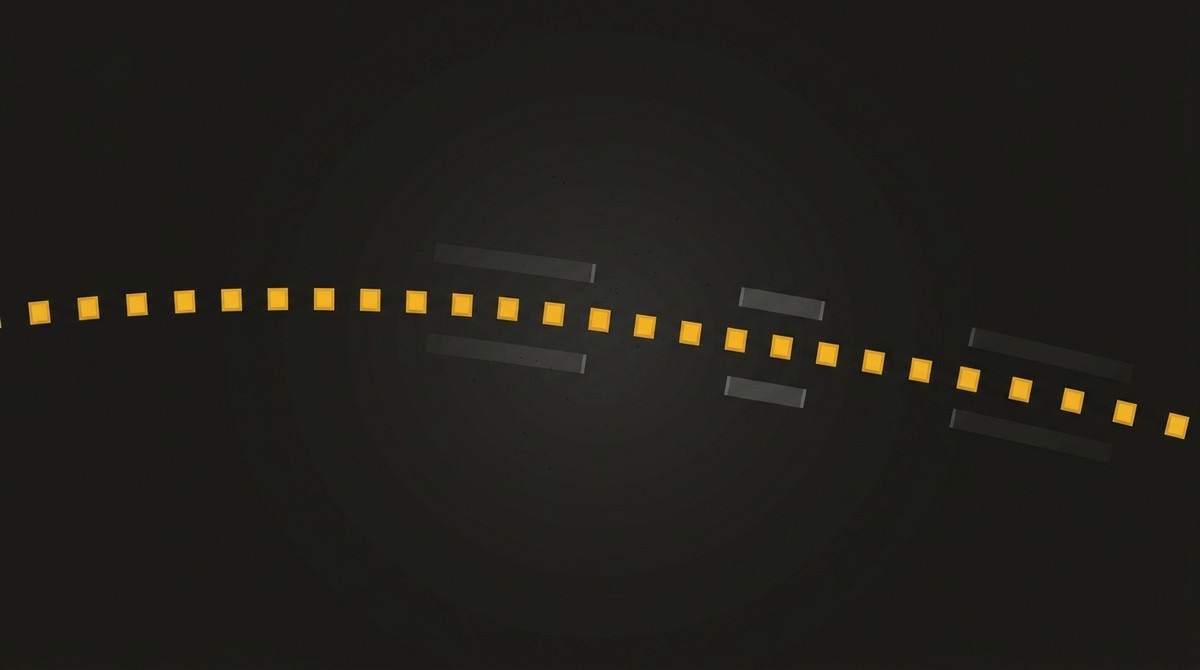 Row of yellow temporary pavement marker tabs curving across fresh asphalt past the ghost scars of removed lines